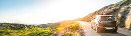 rental car in spain mountain landscape road at sunset | Von AA+W
