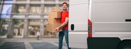 Red courier outside carries parcels with a withe van for deliveries of shipments. Von alphaspirit